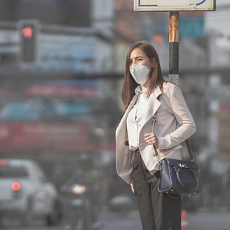 Asian woman are going to work.she wears N95 mask.Prevent PM2.5 dust and smog