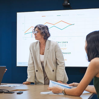 Group of gen z multiethnic businesspeople team meeting discussion in corporate office meeting room, presentation on TV screen. Workplace diversity, work life, team building, business people lifestyle