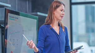 Businesswoman presenting in a modern office meeting room