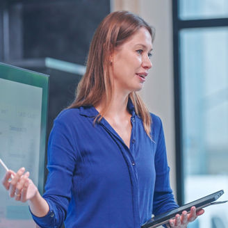 Businesswoman presenting in a modern office meeting room
