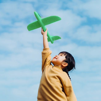 Kid holding dummy aeroplane