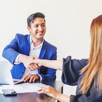 Welcome onboard concept. Indian man and woman shake hands in office