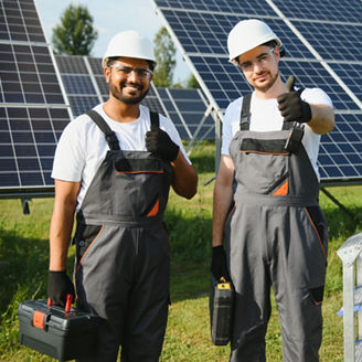 Two skilled workers or craftsmen wearing working gray uniforms, technicians are installing solar panels on a solar farm for clean energy and electricity supply.