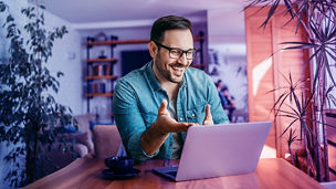 man laughing at laptop