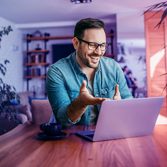 man laughing at laptop