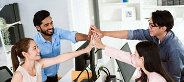 Team of young Asian, Indian and Thai entrepreneurs and startup have business meeting, encouraging and high five each other for good energy to accomplish successful marketing plan. Diversity of team.