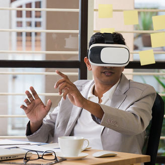 indian male using virtual reality technology at work

