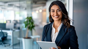 Confident Mixed-Race Businesswoman Holding Digital Tablet in Modern Office