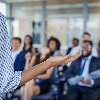Rear-view of lady addressing business meeting