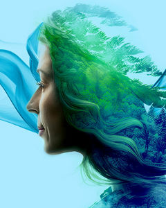 Lady with hair blowing and trees in background