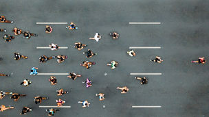 Aerial view of marathon city runners. One person leading marathon.