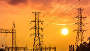 high voltage electric pillars in substation on  sunset background  