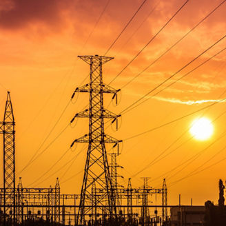 high voltage electric pillars in substation on  sunset background  