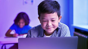 little boy using laptop