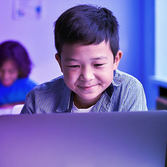 little boy using laptop