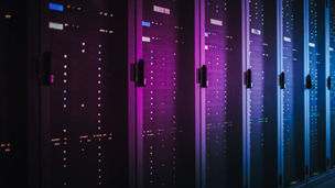 Shot of Dark Data Center With Multiple Rows of Fully Operational Server Racks. Modern Telecommunications, Cloud Computing, Artificial Intelligence, Database, Supercomputer. Pink Neon Light.