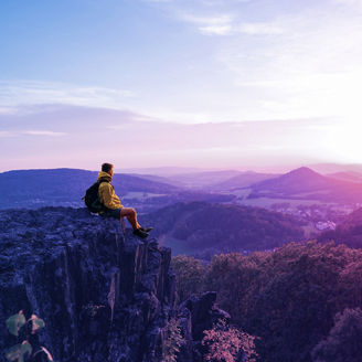 Male hiker sitting on rock