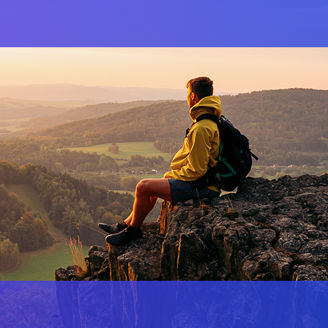 Male hiker sitting on rock