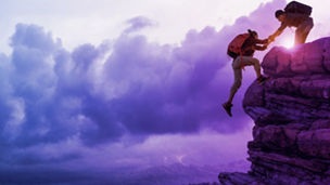 male hikers climbing rock