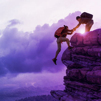 male hikers climbing rock
