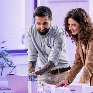 Man and woman discussing with laptop