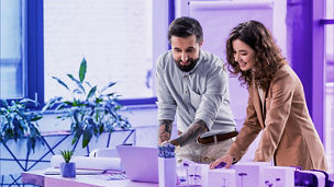 man and woman discussing with laptop