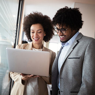 Man and woman looking at a computer blue background banner