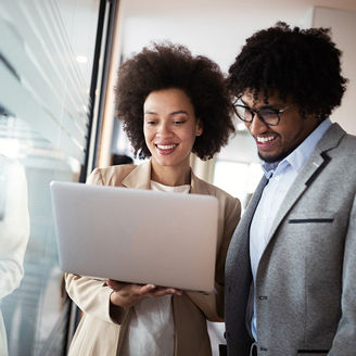 Man and woman looking at a computer blue background