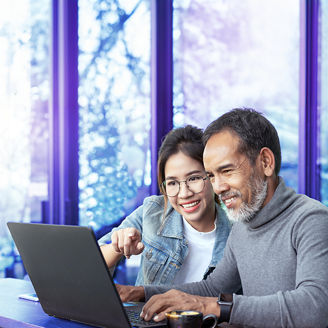 man and woman looking at a laptop