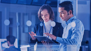 man-and-woman-looking-at-a-tablet-in-a-lab