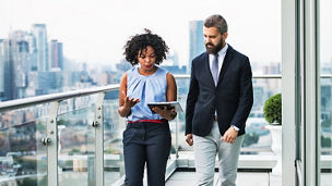 man and woman looking at notepad