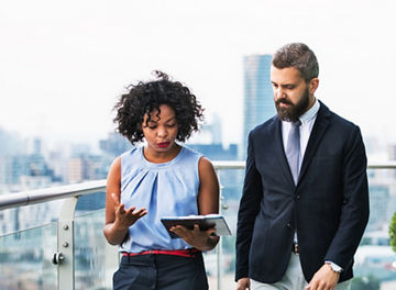 man and woman looking at notepad