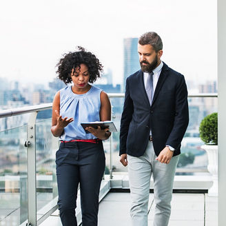 man and woman looking at notepad