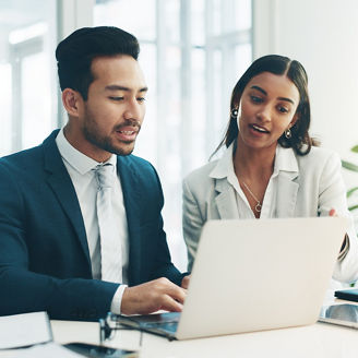 Businessman, laptop and team in finance discussion, project planning or schedule at office. Asian man and business woman working on computer for corporate statistics or financial plan at workplace.