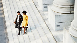 Man and woman walking down stairs together