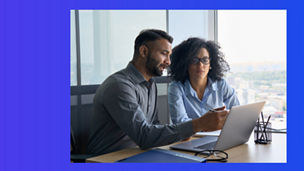 man and women with specs looking at laptop banner