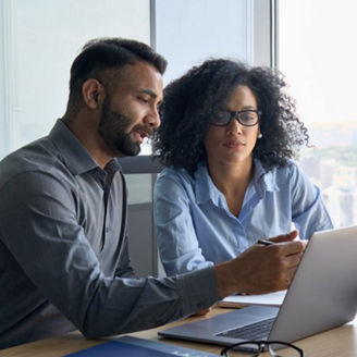 man and women with specs looking at laptop