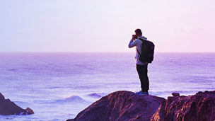 man clicking picture of ocean banner