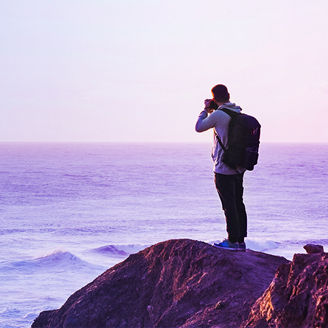 man clicking picture of ocean banner