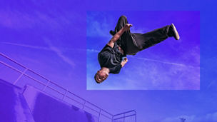 Young Parkour and Freerunning athlet doing a backflip from a wall in an urban enviroment with a blue sky in de background, jumping tumbling  Gymnastics training concept