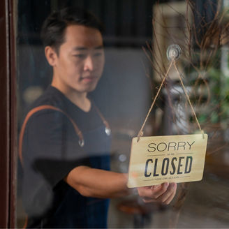 man-hanging-closed-board