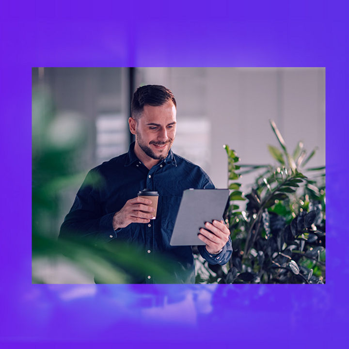 Man holding coffee cup and ipad banner