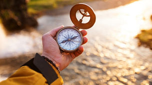 man holding compass