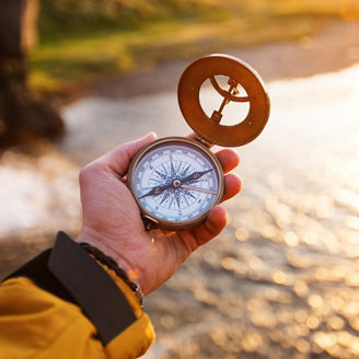 man holding compass