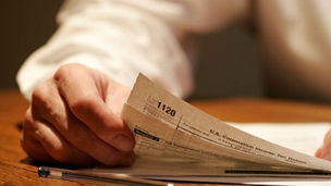 Man holding paper and pen
