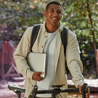 man walking with his laptop in his arms