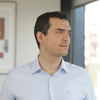 Man in light blue shirt looking outside the window