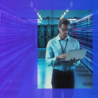 Man in serverroom, with laptop in hand