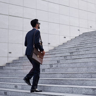 man in suit climbing stairs