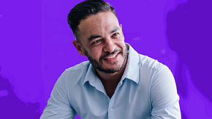 Man in white shirt leaning forward